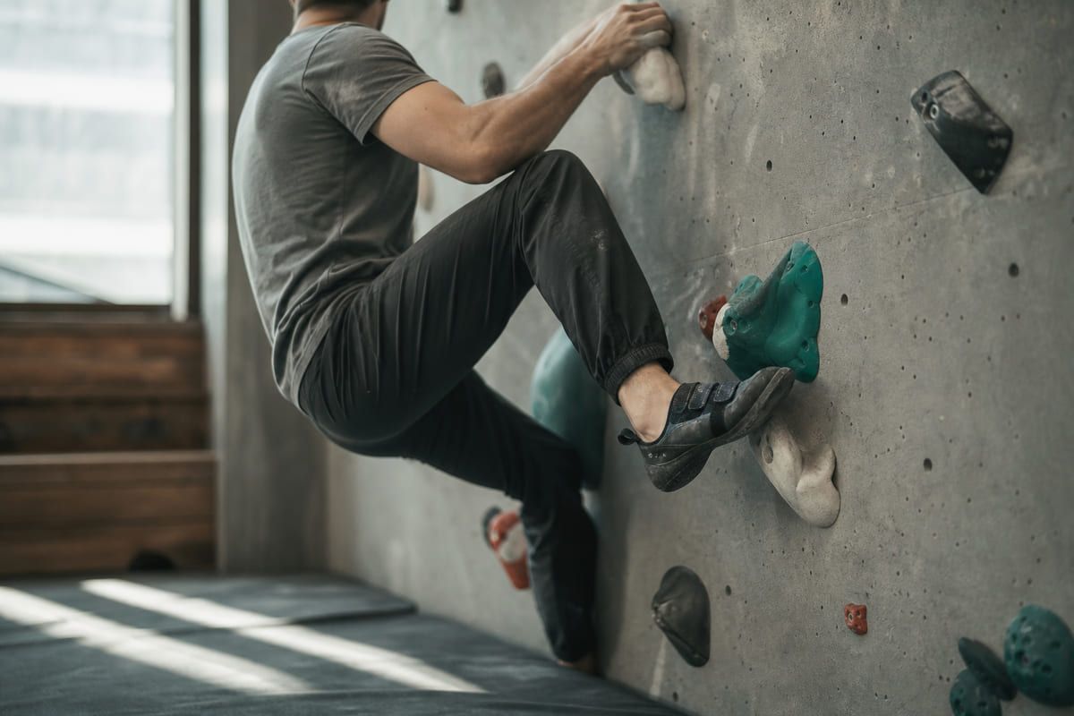Beginner climber focusing on technique.